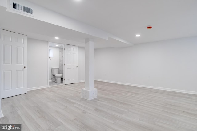 finished basement featuring baseboards, recessed lighting, light wood-style flooring, and visible vents