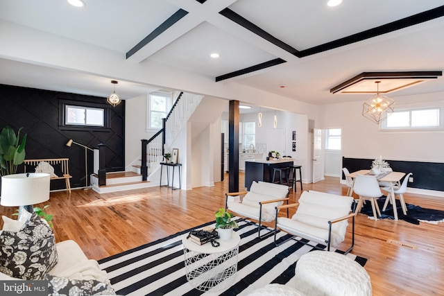 living room featuring recessed lighting, baseboards, stairway, and light wood-type flooring
