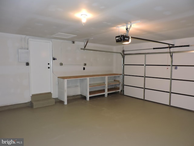 garage featuring a garage door opener and electric panel