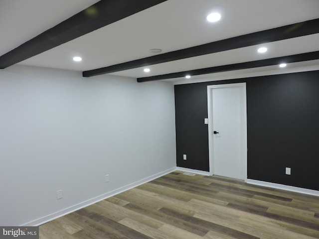 finished below grade area with recessed lighting, baseboards, and wood finished floors
