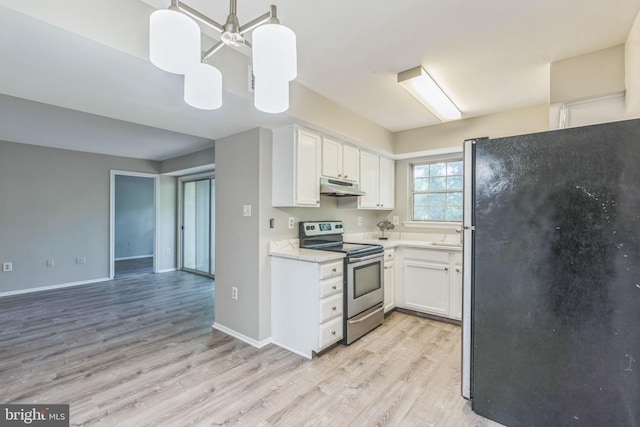 7743 Inversham Dr Unit 197, Falls Church, VA 22042 - kitchen with freestanding refrigerator, electric range, under cabinet range hood, and light wood-type flooring