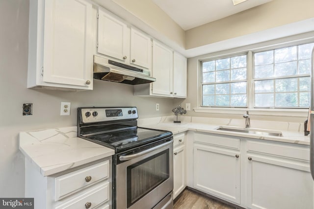 7743 Inversham Dr Unit 197, Falls Church, VA 22042 - kitchen with stainless steel electric stove, under cabinet range hood, white cabinetry, wood finished floors, and light stone counters