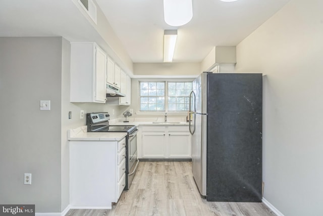 7743 Inversham Dr Unit 197, Falls Church, VA 22042 - kitchen with appliances with stainless steel finishes, under cabinet range hood, light wood finished floors, and white cabinets