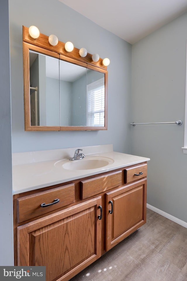 bathroom featuring vanity and wood finished floors