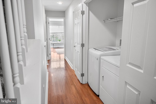 2738 Tilton St, Philadelphia, PA 19134 - clothes washing area featuring light wood-style floors, laundry area, baseboards, and washing machine and clothes dryer
