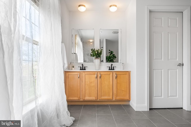 2738 Tilton St, Philadelphia, PA 19134 - bathroom featuring double vanity, baseboards, tile patterned flooring, and a sink