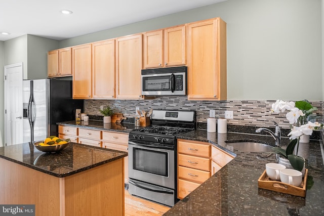 2738 Tilton St, Philadelphia, PA 19134 - kitchen featuring appliances with stainless steel finishes, decorative backsplash, a sink, and light brown cabinets