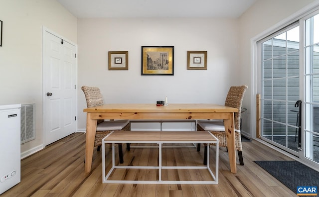 dining room with baseboards and wood finished floors