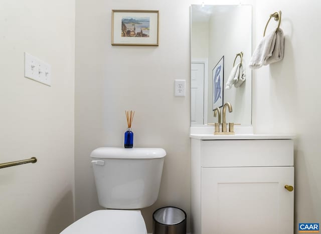 half bathroom featuring toilet and vanity
