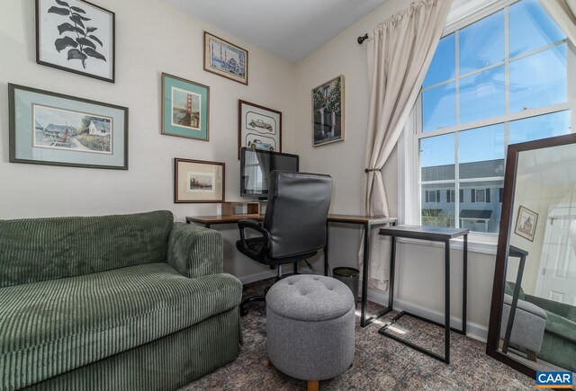 carpeted office featuring baseboards