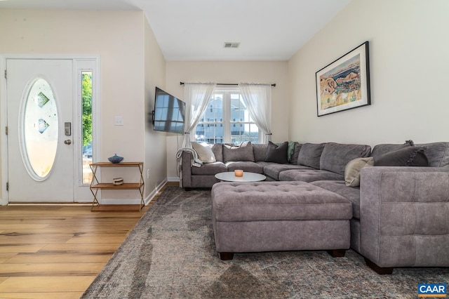 living room featuring wood finished floors and visible vents