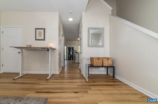 hall with recessed lighting, baseboards, and light wood-type flooring