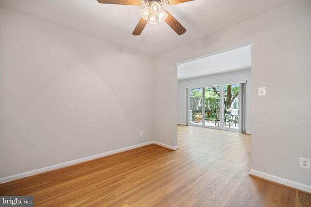 empty room featuring baseboards, ceiling fan, and light wood finished floors