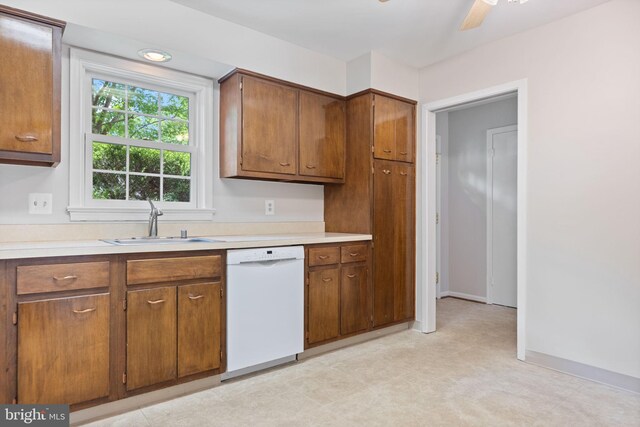 kitchen with a sink, brown cabinetry, and dishwasher