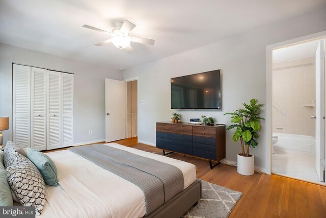 bedroom with ceiling fan, wood finished floors, baseboards, a closet, and connected bathroom
