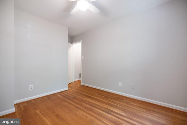 unfurnished room featuring a ceiling fan, baseboards, and light wood-style floors