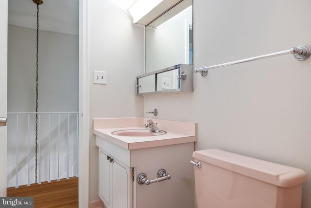 half bathroom with vanity and toilet