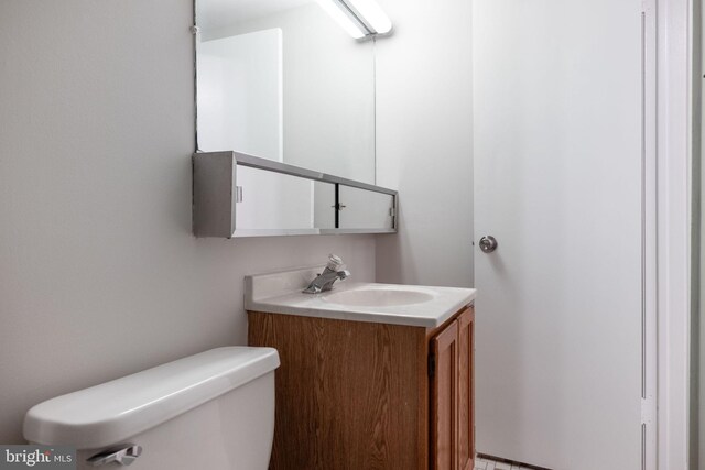 half bath with vanity and toilet