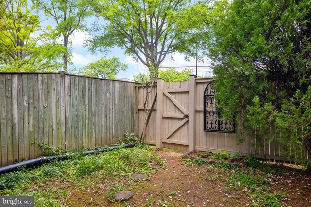 view of yard with fence and a gate