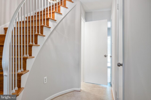 stairway featuring baseboards
