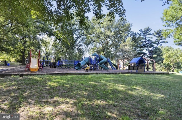 community jungle gym featuring a lawn