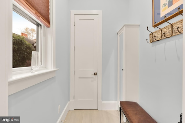 mudroom with baseboards and light wood-style flooring
