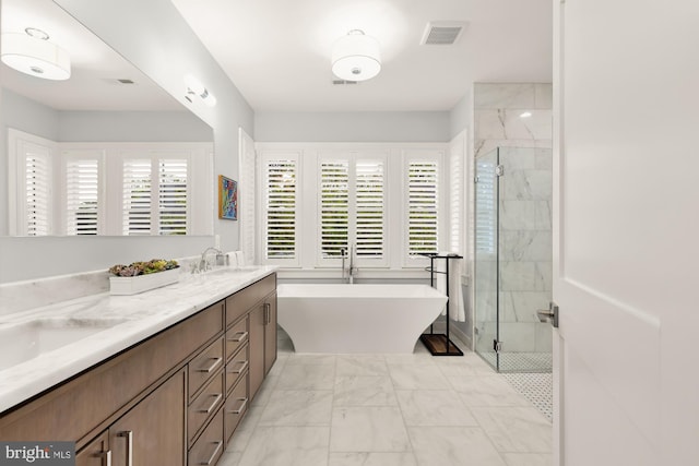 bathroom with a sink, marble finish floor, a marble finish shower, and visible vents