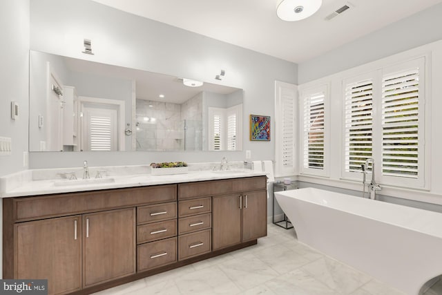 bathroom featuring double vanity, a freestanding bath, a sink, and a stall shower