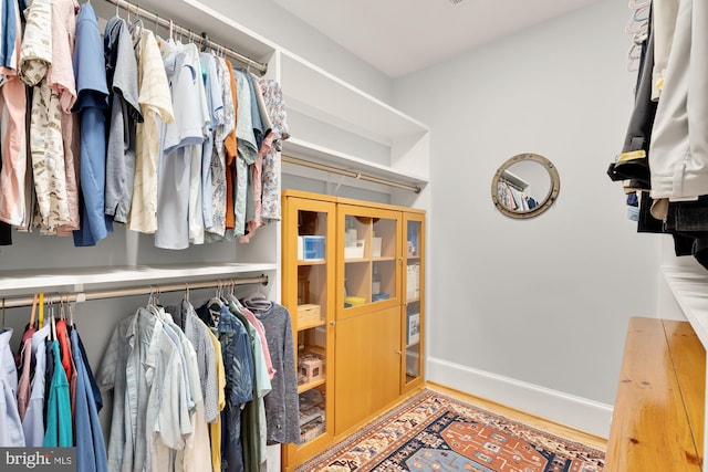 spacious closet with wood finished floors