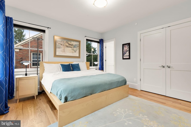 bedroom with light wood-style floors and a closet