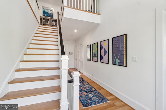 stairs with baseboards and wood finished floors