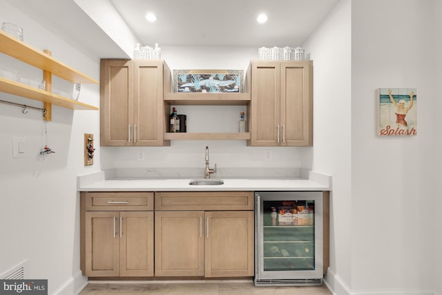 bar featuring wet bar, visible vents, a sink, baseboards, and wine cooler