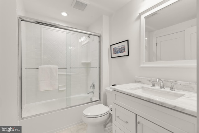 bathroom with vanity, toilet, recessed lighting, combined bath / shower with glass door, and visible vents