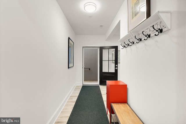 mudroom with light wood-type flooring and baseboards