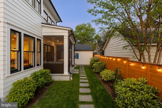 view of yard with a sunroom and fence