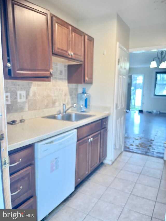 2407 Matthew Henson, Landover, MD 20785 - kitchen featuring a sink, backsplash, light countertops, and white dishwasher