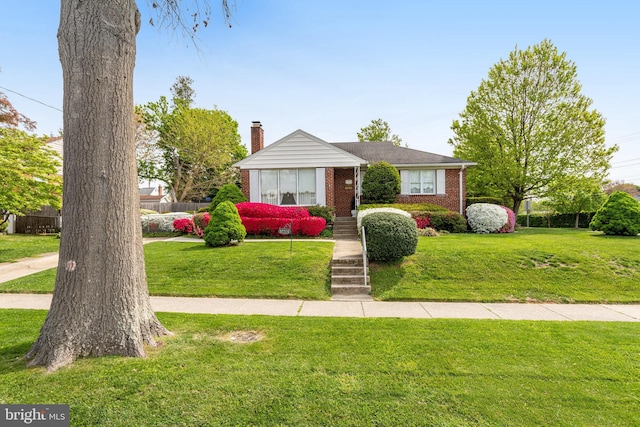 bungalow-style home featuring a chimney, brick siding, fence, and a front lawn