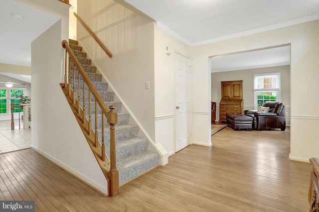 7117 Stanchion Ln, Burke, VA 22015 - stairs featuring wood finished floors, crown molding, a ceiling fan, and baseboards