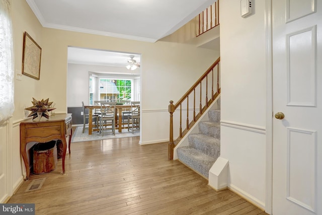 7117 Stanchion Ln, Burke, VA 22015 - foyer entrance featuring stairs, light wood-style flooring, ceiling fan, and crown molding
