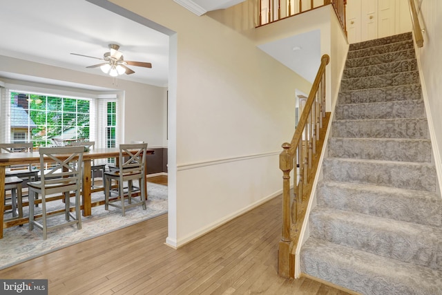 7117 Stanchion Ln, Burke, VA 22015 - staircase featuring a ceiling fan, hardwood / wood-style floors, baseboards, and crown molding