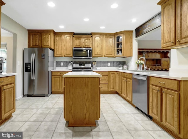 7117 Stanchion Ln, Burke, VA 22015 - kitchen with appliances with stainless steel finishes, a center island, a sink, light countertops, and glass insert cabinets