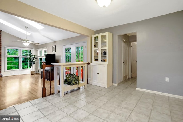 7117 Stanchion Ln, Burke, VA 22015 - living area with a skylight, baseboards, a ceiling fan, and light tile patterned flooring