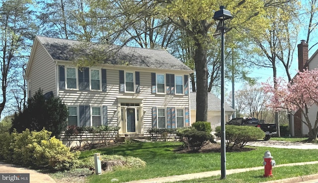 7117 Stanchion Ln, Burke, VA 22015 - colonial-style house featuring a front yard and roof with shingles