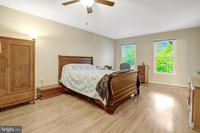 7117 Stanchion Ln, Burke, VA 22015 - bedroom with light wood-type flooring, baseboards, and a ceiling fan