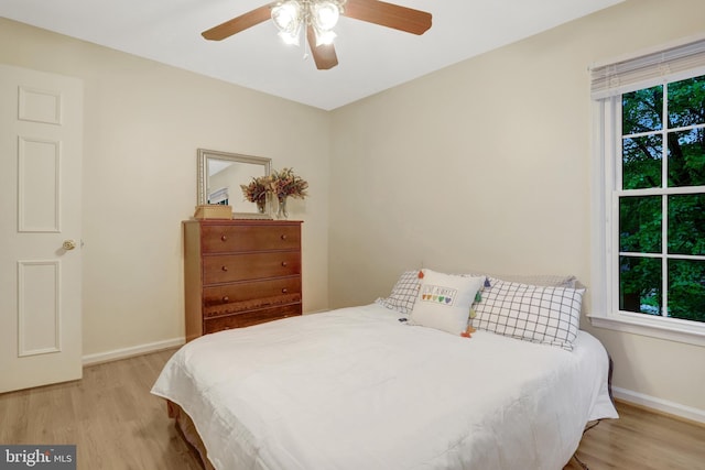 7117 Stanchion Ln, Burke, VA 22015 - bedroom featuring light wood finished floors, baseboards, and a ceiling fan