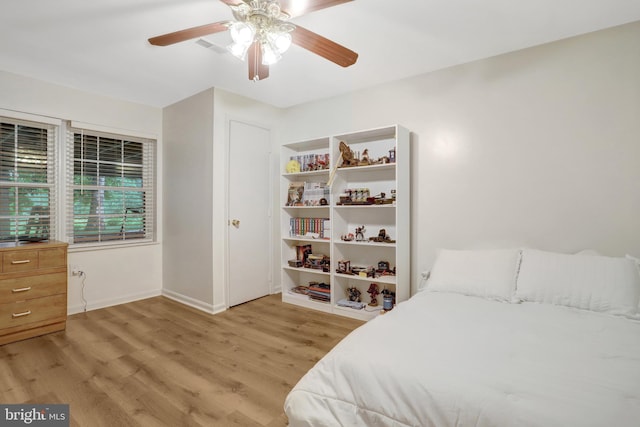 7117 Stanchion Ln, Burke, VA 22015 - bedroom with light wood-style floors, baseboards, and ceiling fan
