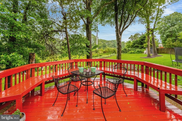 7117 Stanchion Ln, Burke, VA 22015 - deck featuring a trampoline, a yard, and outdoor dining space