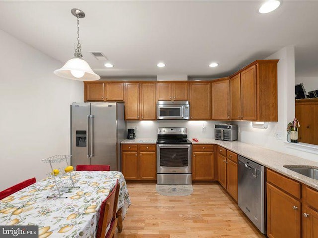 139 Gazebo Ln, Middletown, DE 19709 - kitchen featuring recessed lighting, light wood-style floors, brown cabinets, and appliances with stainless steel finishes