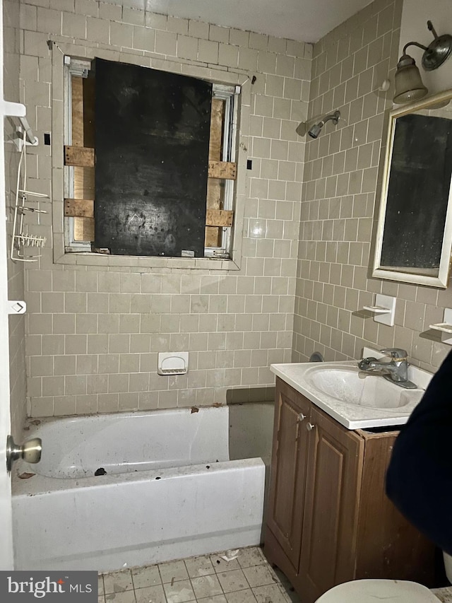 full bathroom with tile walls, tub / shower combination, and vanity