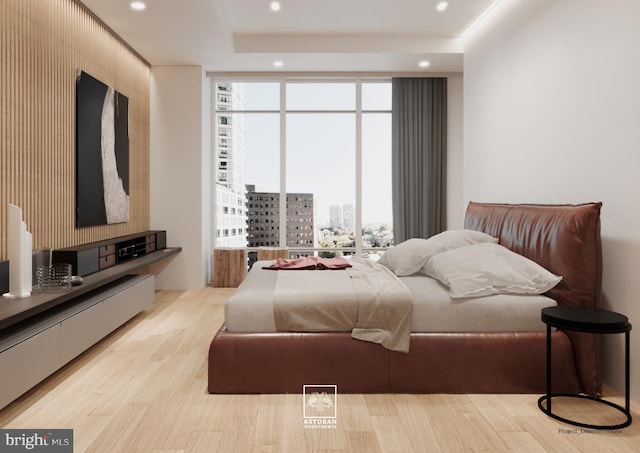 bedroom featuring recessed lighting, multiple windows, wood finished floors, and expansive windows